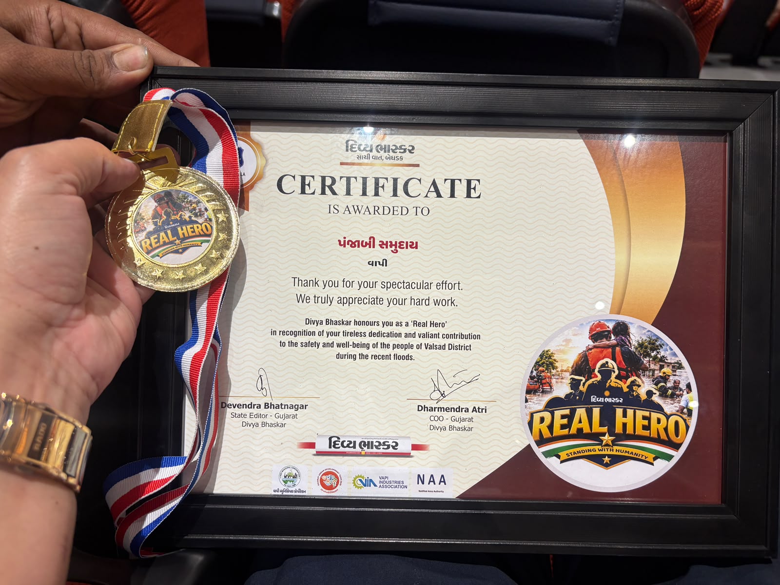 REAL HERO certificate and medal awarded to Punjabi Samaj Vapi for service during the recent floods