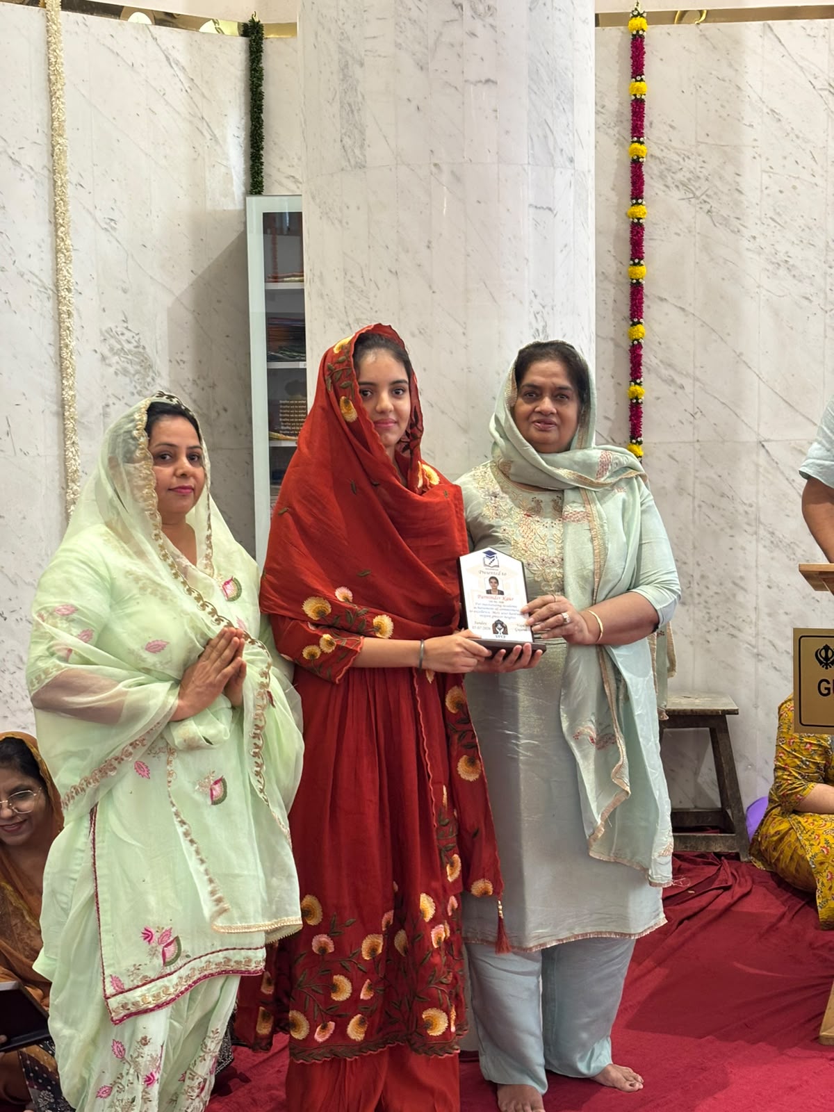 VPCF trustees felicitating a student with a Student Achievement Award plaque